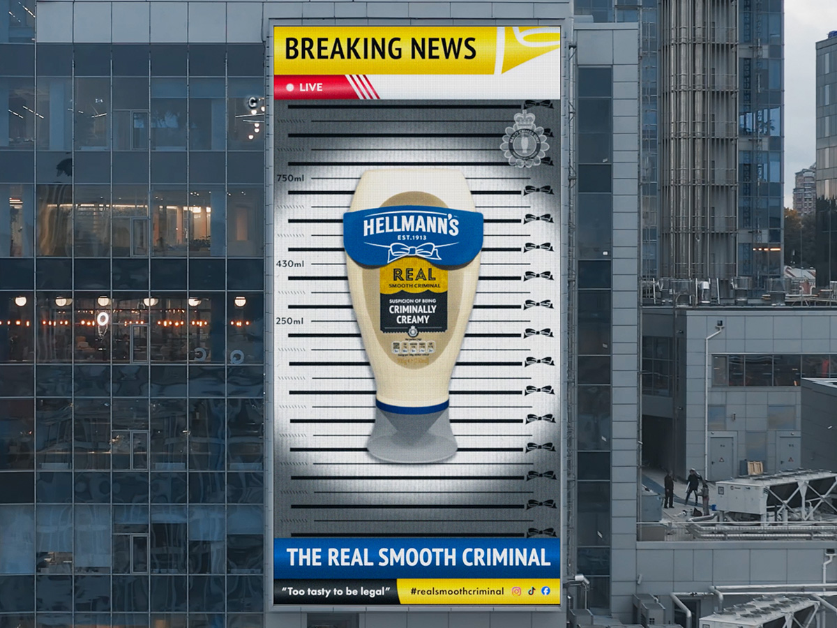 Breaking news Hellmann's arrested billboard on the side of building.