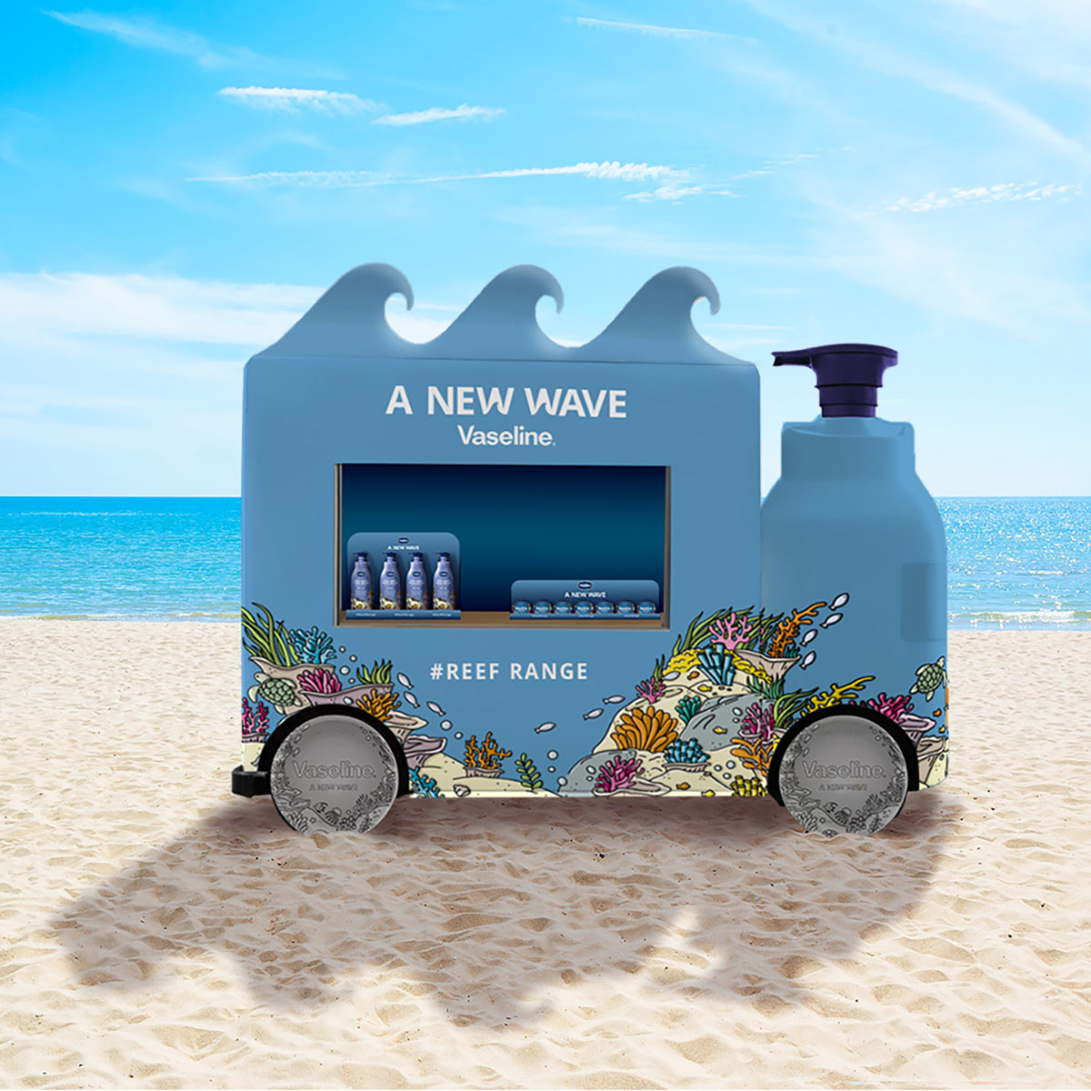 Pop-up beach cart shaped like a Vaseline bottle with wave top, featuring coral reef graphics and promoting the Reef Range sunscreen line with the slogan ‘A New Wave.