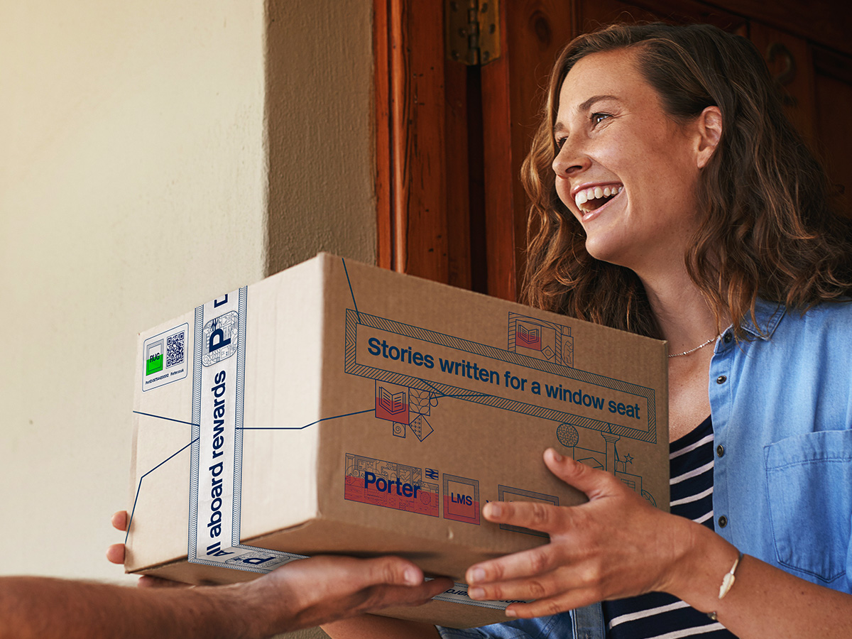 Person being handed Porter branded parcel by neighbour.
