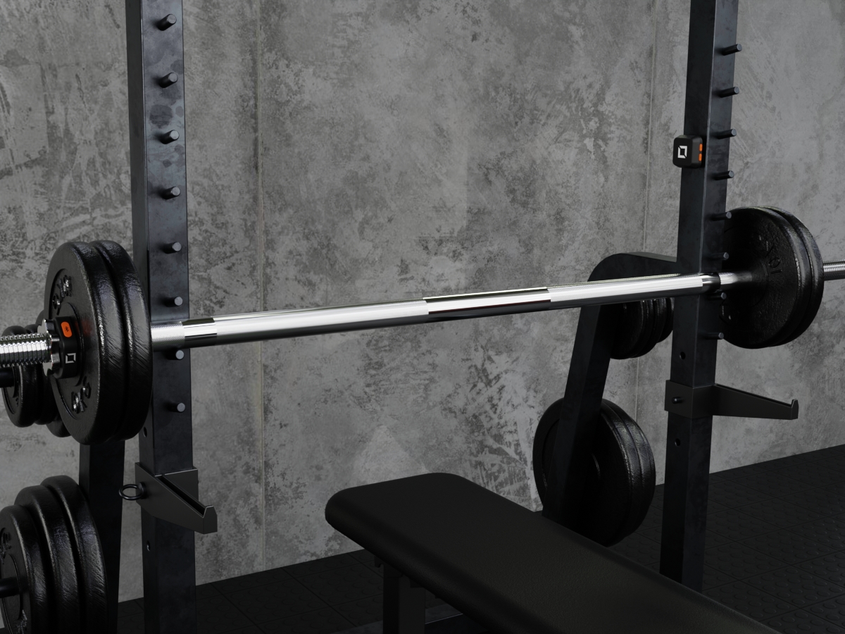 CHK BOX device on a rack inside the gym and CHK BOX tracking collars on the sleeves of a barbell